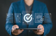 © Nirusmee - Quality assurance and certification concept with hands protecting digital approval checkmark and compliance documents. Symbol of quality control, verification, standards and business trust.