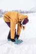 © ADDICTIVE STOCK - Woman fasten ski boot in snowy japan landscape