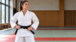 © VHG Reload - Female Judo Black Belt Athlete Standing Confidently in Martial Arts Dojo