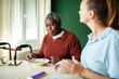 © Davor - Caregiver helping senior man eat soup at home