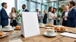 © Maimunaislam - Blank White Table Tent Sign Mockup on Wooden Conference Room Table with Coffee Cups and Croissants and Corporate Business Networking Event Background