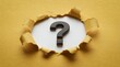 © Sojib - Black question mark symbol appearing through torn yellow paper hole, conceptual mystery and problem solving background, curiosity and FAQ concept