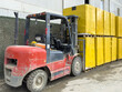 © Travel 'n' Lifestyle - View of a red forklift transporting a stack of yellow-wrapped pallets in an industrial area in Istanbul, Istanbul, Turkiye.