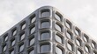 © HETA DESIGN - Close-up architectural photograph of a curved precast concrete tower corner with rounded window openings against a pale sky. Sculptural modern facade and geometric building design