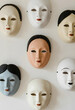 © Pixel-Shot - Diversity and inclusion concept, collection of various human face masks multicultural identity and social unity on a plain white wall background