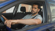 © Krakenimages.com - Man with seatbelt resting arm on car door and hand on steering wheel, looking sideways in street; contemplation.