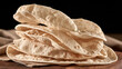 © Jhati - Stack of freshly baked thin flatbread rotis on a wooden board with indian bread