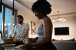 © Niyaz Tavkaev/Stocksy - Cheerful black woman cooking romantic dinner with boyfriend