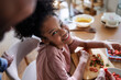 © Jovo Jovanovic/Stocksy - Cheerful girl smiling while preparing strawberries in the kitchen