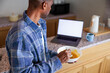 © Jovo Jovanovic/Stocksy - A man prepares food following a digital recipe