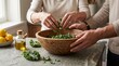 © Friedbert - Shared hands prepare a healthy kale salad