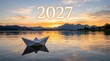 © Abdul - Happy new year 2027 paper boat floating on calm water at golden sunset