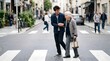 © Rei - Young man helping elderly woman cross busy city street walking together