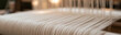 © pattozher - Woven Threads: Close-up of a traditional loom with taut warp threads ready for weaving, showcasing the intricate detail and texture of textile creation.