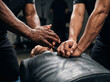 © VISUAL BACKGROUND - Physical therapist applying deep tissue pressure to lower back and glutes