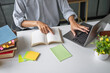 © Charlie's - Asian Man Adult Learner Using Laptop for Online Study and Education Technology Representing Professional Development and Lifelong Learning.
