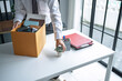 © Charlie's - Businessman Carrying Cardboard Box packing Stuff Resign Depress or carrying business cardboard box Change of job or fired from company resign.