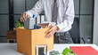 © Charlie's - Businessman Carrying Cardboard Box packing Stuff Resign Depress or carrying business cardboard box Change of job or fired from company resign.