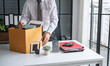 © Charlie's - Businessman Carrying Cardboard Box packing Stuff Resign Depress or carrying business cardboard box Change of job or fired from company resign.