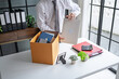 © Charlie's - Businessman Carrying Cardboard Box packing Stuff Resign Depress or carrying business cardboard box Change of job or fired from company resign.
