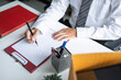 © Charlie's - Businessman Writing Resignation Letter in Modern Office Representing Career Change Employment Transition and New Professional Direction