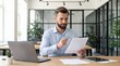© 5 Grace Media - Focused Businessman Examining Documents with Magnifying Glass in Modern Office Setting.