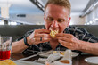 © KseniaJoyg - A young man eats khinkali in a restaurant in Georgia