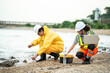 © winnievinzence - A team collects water and soil samples along a polluted riverbank to check for contamination and environmental issues, focusing on ecological protection and pollution control.