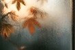 © Trendy Graphics - Rainy day view through a wet window with autumn leaves and golden light outside
