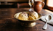 © lam - Traditional zabaglione gelato scoops infused with sweet Marsala wine and garnished with grated dark chocolate, vintage Italian brass dish on dark wood,