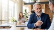 © iravgustin - Active senior business professionals at work. An upbeat older male executive discusses marketing plans with a female coworker.