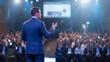 © Rizvi - Professional businessman in blue suit gives an engaging keynote speech during a large corporate conference with bright stage lighting effects