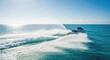 © chaiwat - Sleek blue and white jet ski speeds through turquoise water, kicking up a dramatic spray of white droplets under a bright and sunny sky, blue, holiday, sport