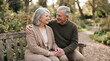 © Maksym - Loving senior couple smiling and embracing on park bench in autumn