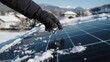 © mushfiqhossein - A gloved hand brushes snow off a residential solar panel on a sunny winter day. Concept for renewable energy efficiency and maintenance during cold weather seasons.