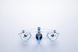 © AdPremium - Top view of a modern transparent glass balance scale with metal weights balanced equally on a white background with copy space