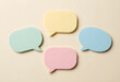© Pixel-Shot - Communication and feedback concept, colorful speech bubbles for brainstorming and social media interaction on a plain neutral background