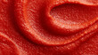 © Olha Havelia - Crushed tomato pulp and juice texture spread across surface covering entire frame vibrant red close-up natural light food background with copy space