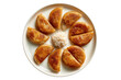 © Adrita - Top view of traditional Bengali taler pitha arranged on white plate with rice powder