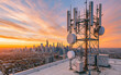 © Oleksiy - Modern 5G and 4G cellular base station equipment installed on a building rooftop