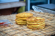 © 완수 안 - Golden fried savory mung bean pancakes stacked on a bamboo mat are displayed for sale at a traditional five day market in South Korea.
