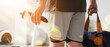 © Pixel-Shot - Healthy lifestyle and fitness routine, person holding water bottle and gym bag after workout in sports club with morning sunlight and lens flare effect