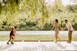 © BGStock72 - Joyful family moments along the serene lakeside pier on a sunny day
