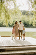 © BGStock72 - Family stroll on a sunny afternoon by the lakeside boardwalk