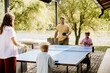 © BGStock72 - Family bonding over table tennis by the serene lakeside
