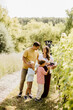 © BGStock72 - Family enjoying a sunny day among grapevines during harvest season