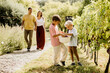 © BGStock72 - Children enjoying a joyful moment while picking grapes in a vineyard