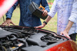 © Charlie's - Insurance Agent Consulting with Vehicle Owner About Red Car Damage and Auto Insurance Claim for Repair and Compensation.