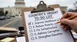 © Kiki - Hand writing a checklist of national priorities in front of a government building