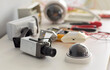 © Studio Romantic - Security cameras and surveillance equipment for installation. Dome units, wiring and tools arranged on a workbench indoors for security system setup. Reliable protection technology concept.